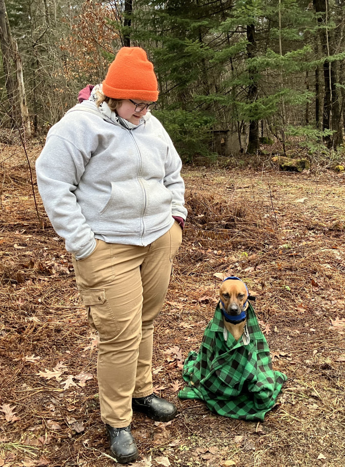 Em wth their dog Hank in th woods
